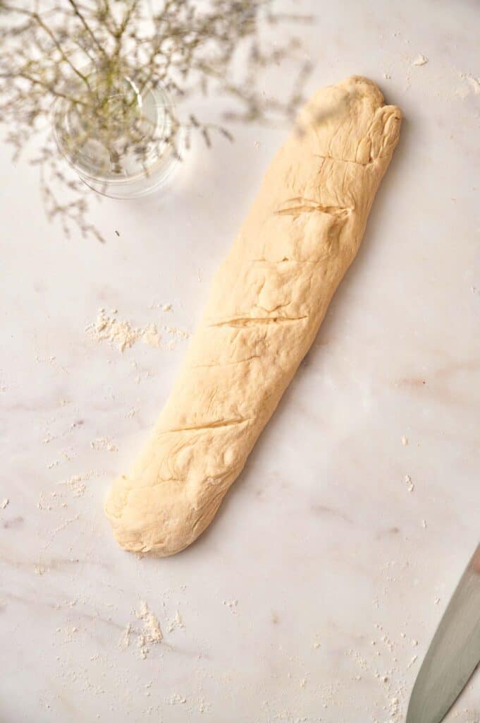 A loaf of bread with a knife next to it.