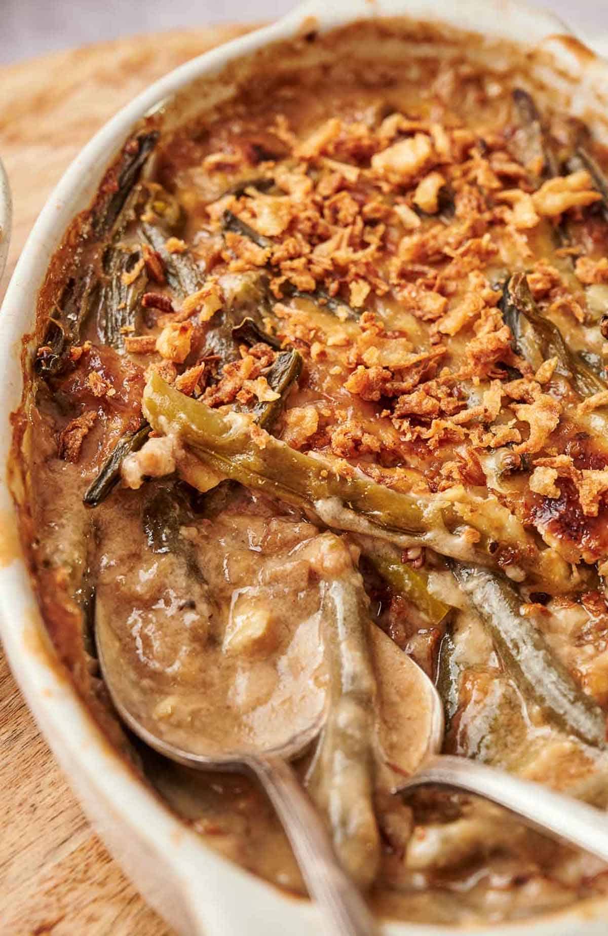 A green bean casserole and two serving spoons.