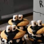 Halloween cookies with black frosting and marshmallows.