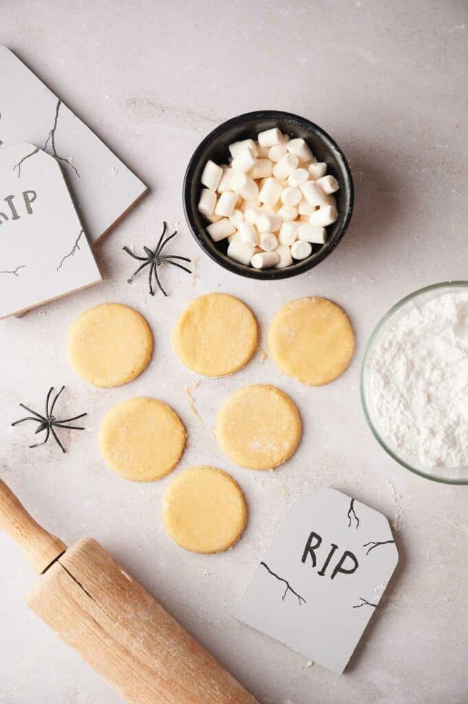 Halloween cookies and a rolling pin on a table.