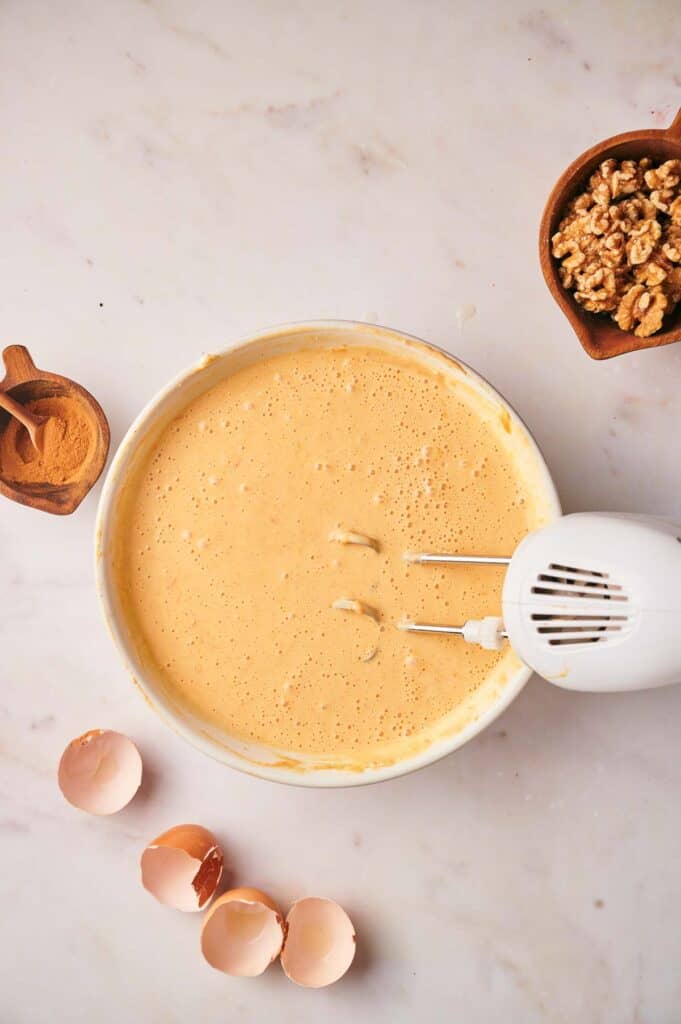 A bowl filled with a mixture of eggs and nuts.