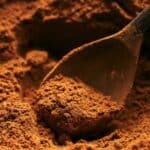 Pumpkin pie spice in a bowl with a spoon.