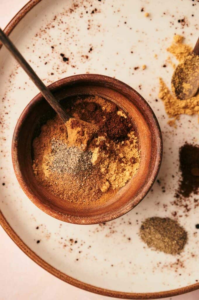 Spices in a bowl on a plate.