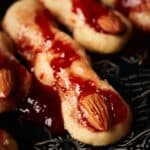 Witch fingers cookies on a black plate.