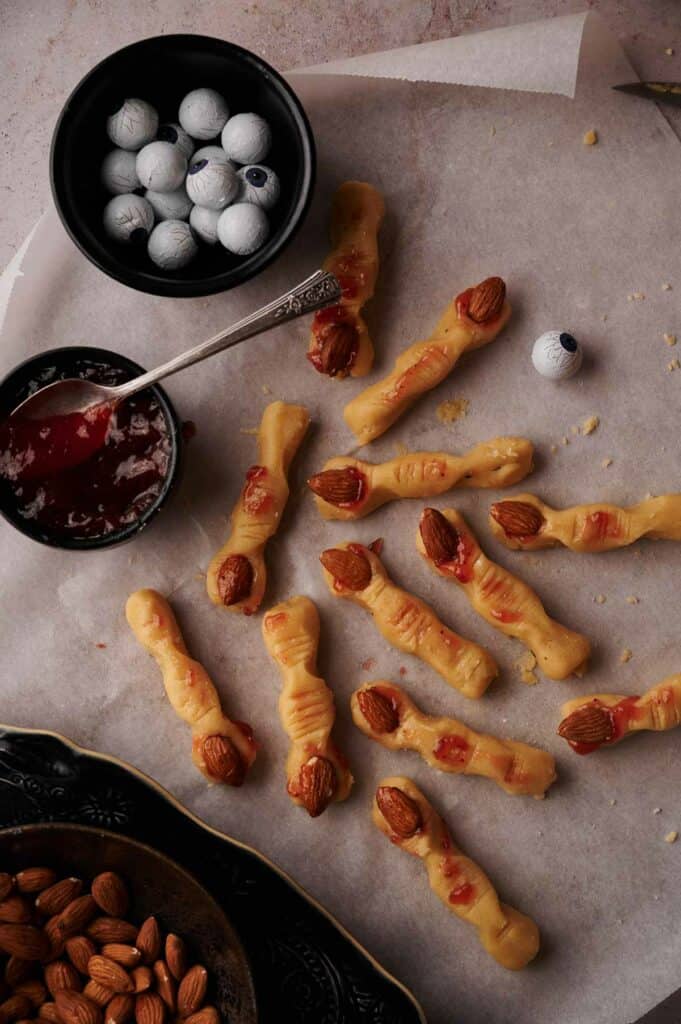 A tray of Halloween finger cookies with almonds and jelly.