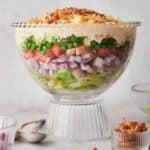 A bowl of salad with the words 7 layer salad.