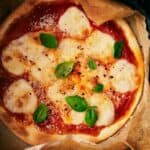 An air fryer pizza on a plate.