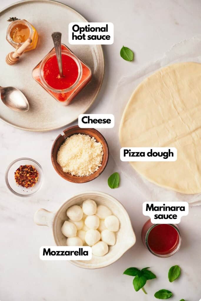 Ingredients for making pizza in an air fryer.