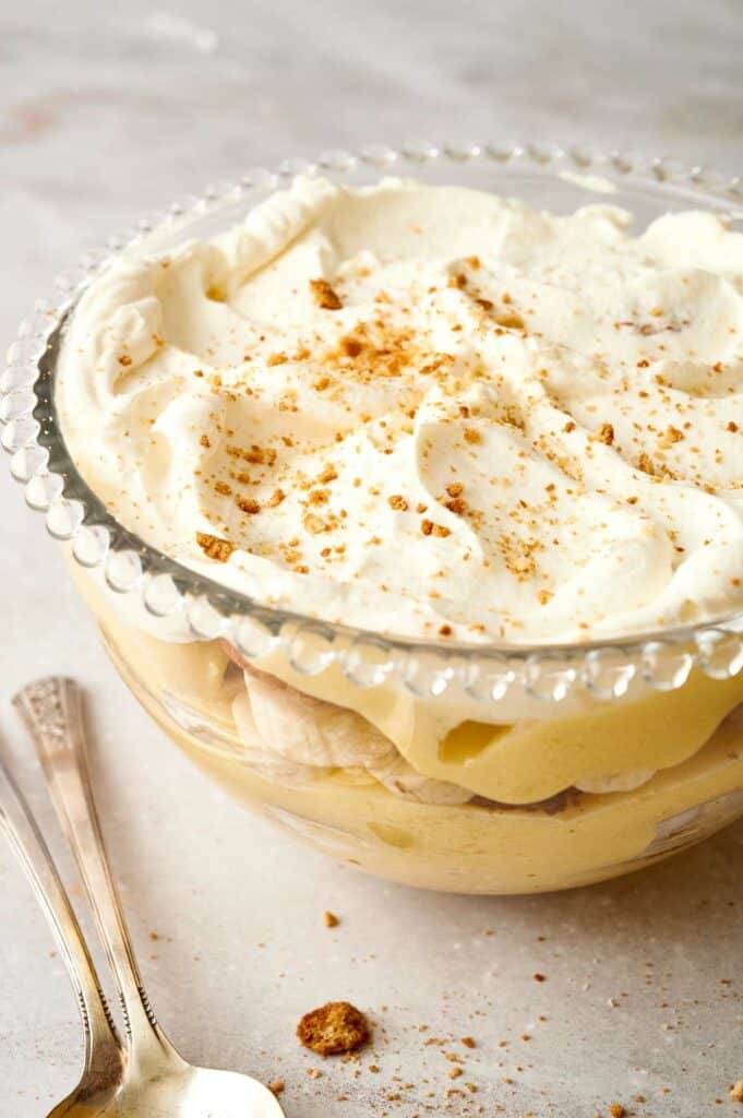 Banana pudding in a bowl with whipped cream.