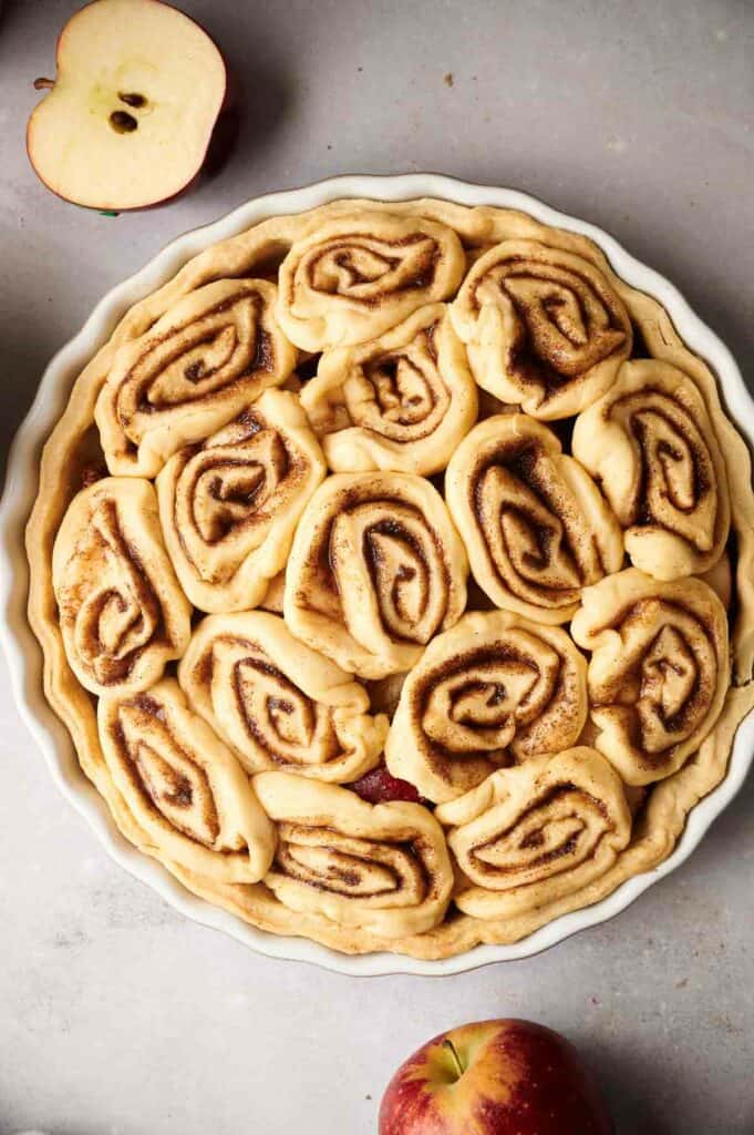 Apple cinnamon roll pie in a pie plate.