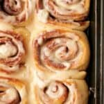 Cinnamon rolls in a pan with icing.