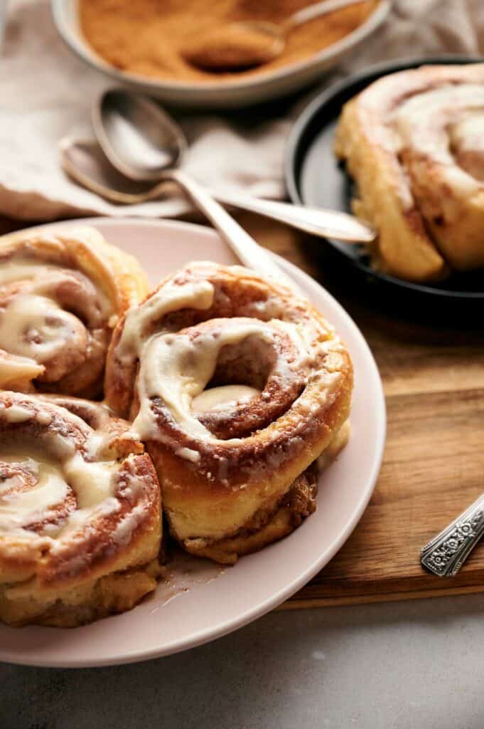 Cinnamon rolls with icing on a plate.