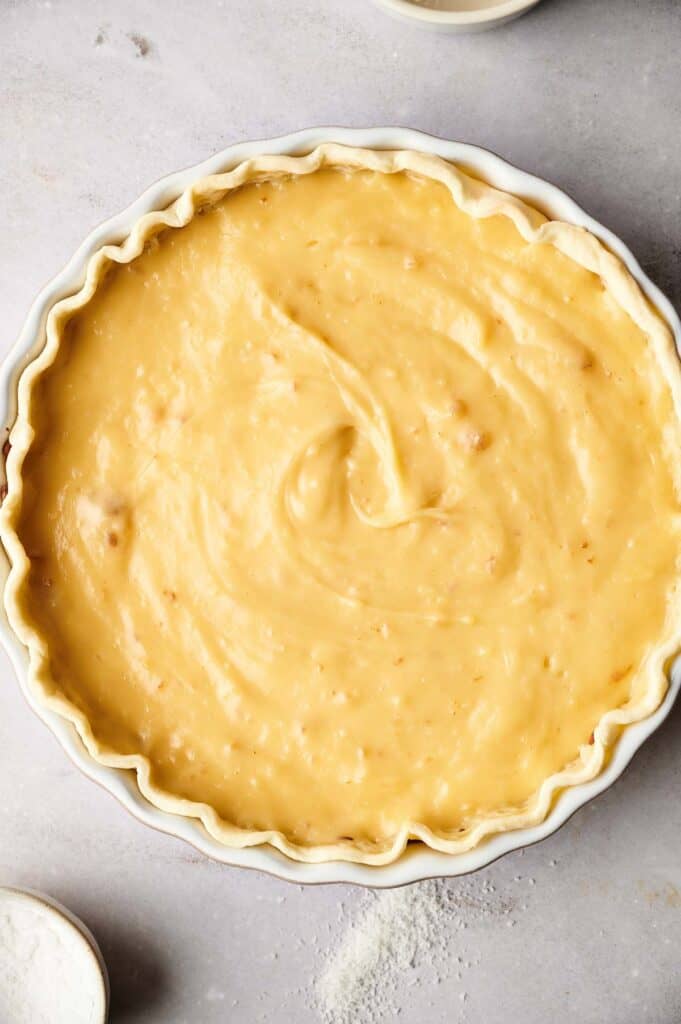 A pie with a yellow filling on a white plate.