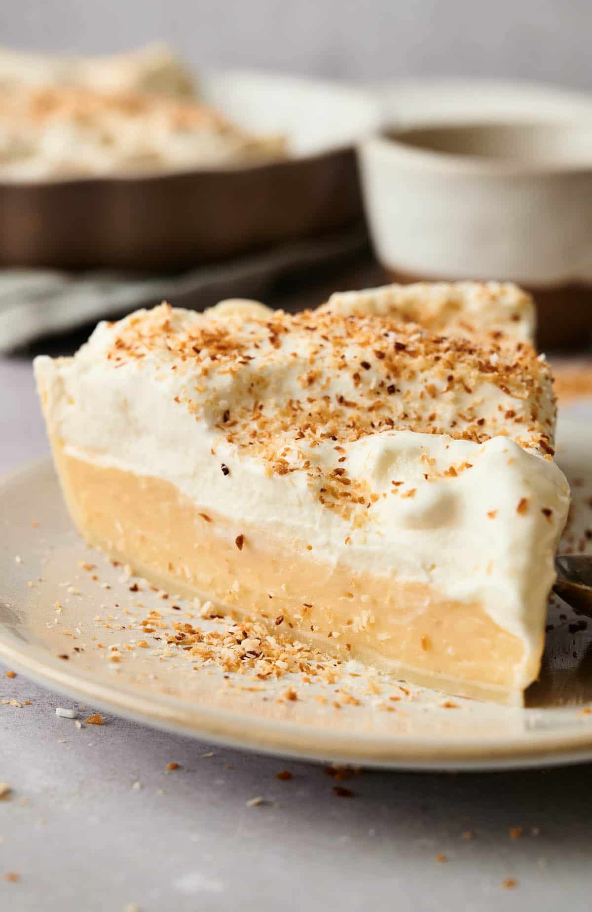 A slice of delicious coconut cream pie on a plate.