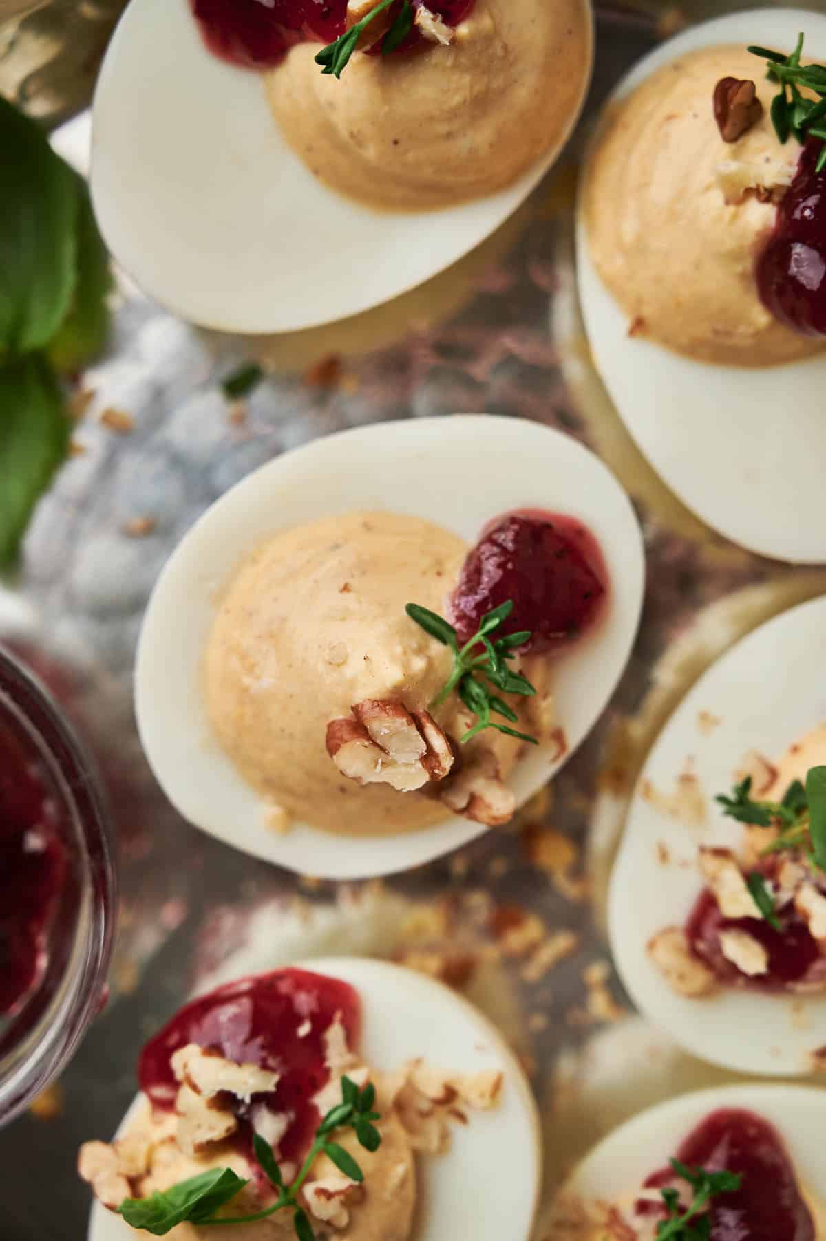 Deviled eggs with cranberry sauce.