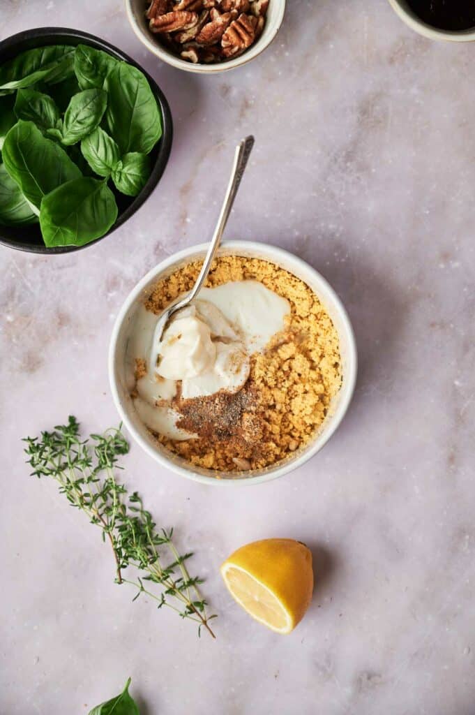 A bowl of egg yolks with lemon and herbs.