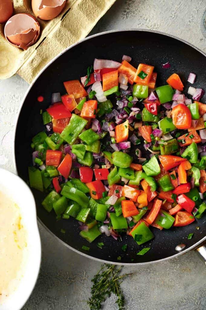 A frying pan full of vegetables.