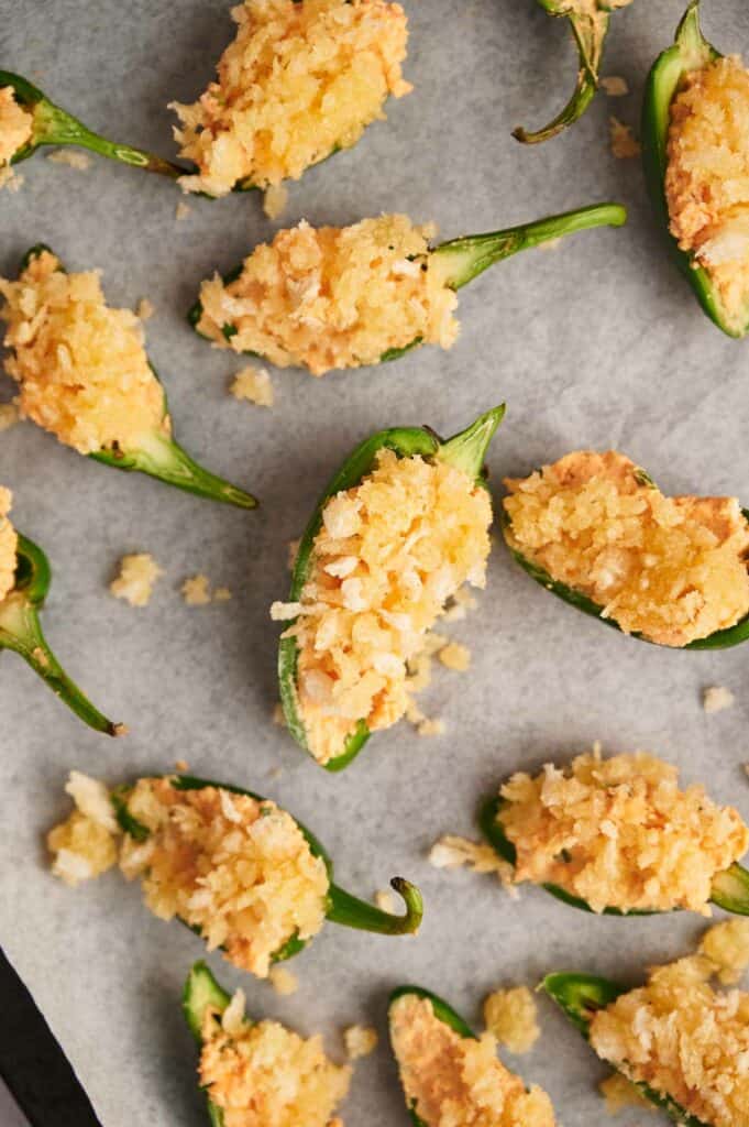 Jalapeno poppers on a baking sheet.