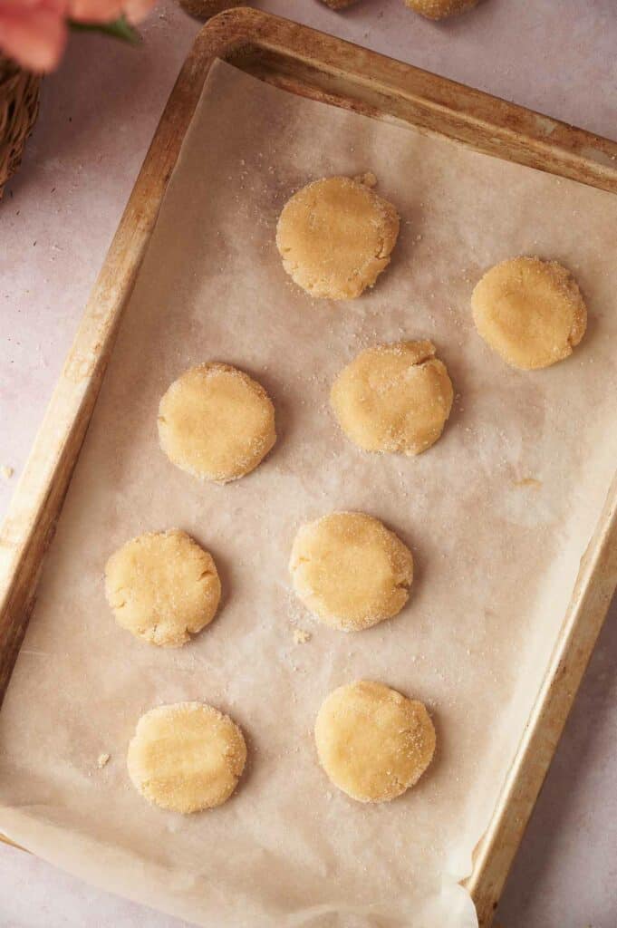 A baking sheet with sugar cookies on it.