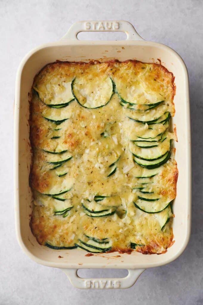 A casserole dish filled with zucchini and cheese.
