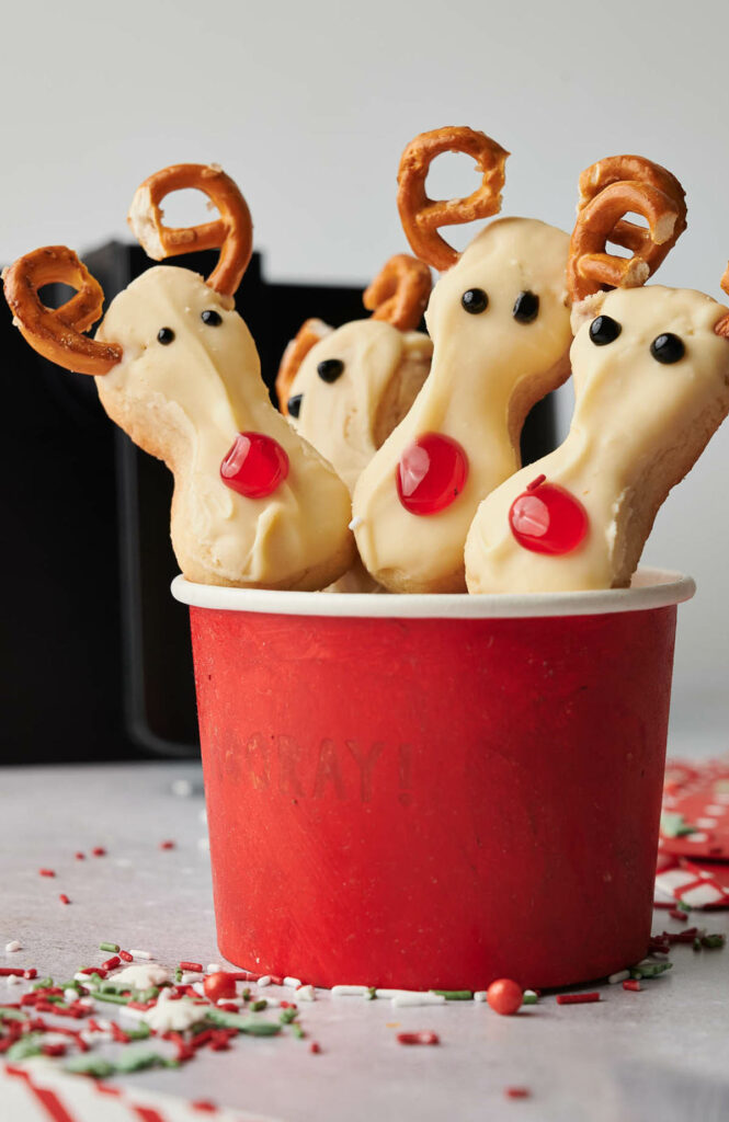 Reindeer Cookies with pretzels in a red cup.