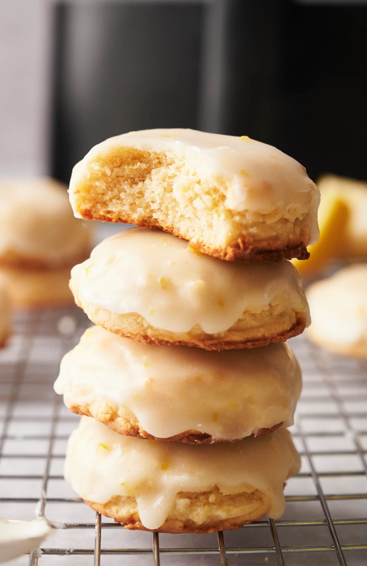 A stack of lemon cookies on a cooling rack.