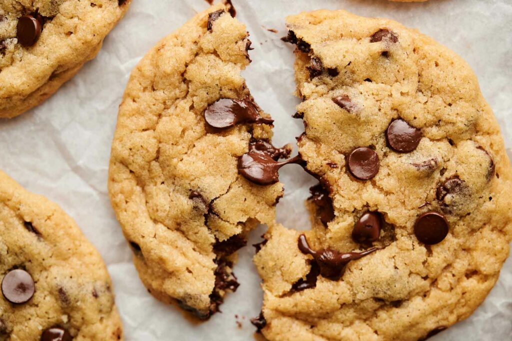 Chocolate chip cookies with a bite taken out of them.