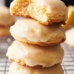 A stack of lemon cookies on a cooling rack.