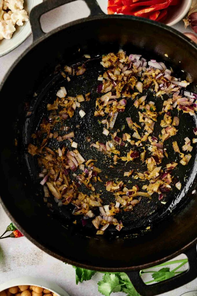 A pot with onions, garlic, and ginger.