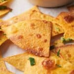 Tortilla chips with guacamole in a bowl.