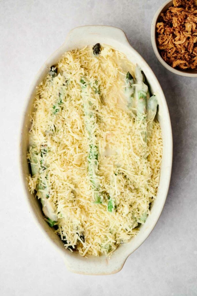 An asparagus casserole with grated cheese on top.