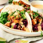 Savory sweet potato tacos on a white plate.