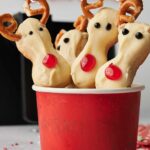 Reindeer Cookies in a red cup with an air fryer at the back.