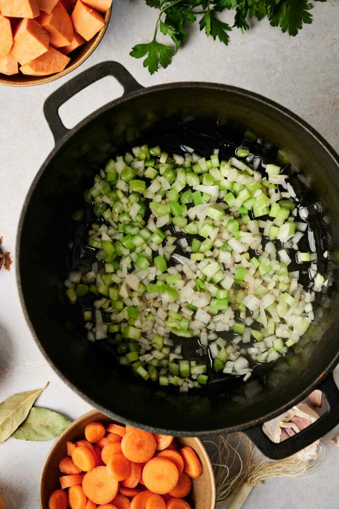onion, garlic, and celery in a pot.