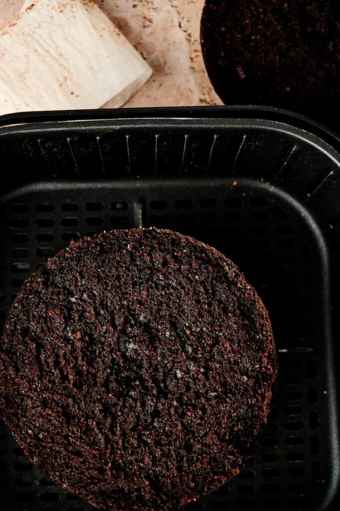 An air fryer chocolate cake on a black tray.
