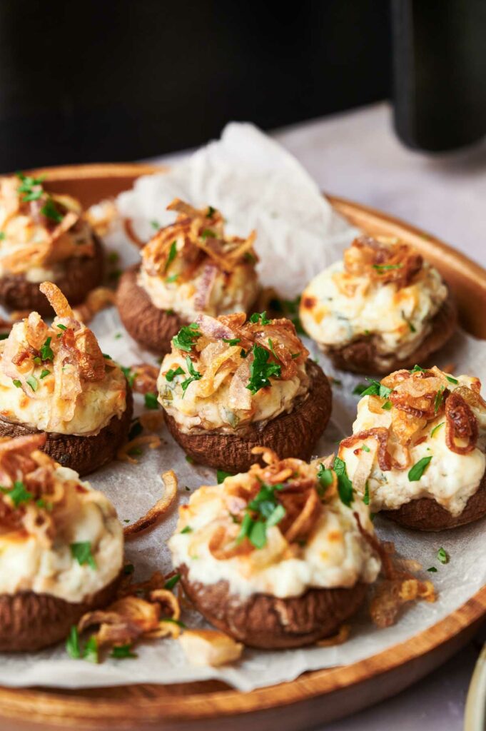 Air fryer stuffed mushrooms topped with cheese and onions.