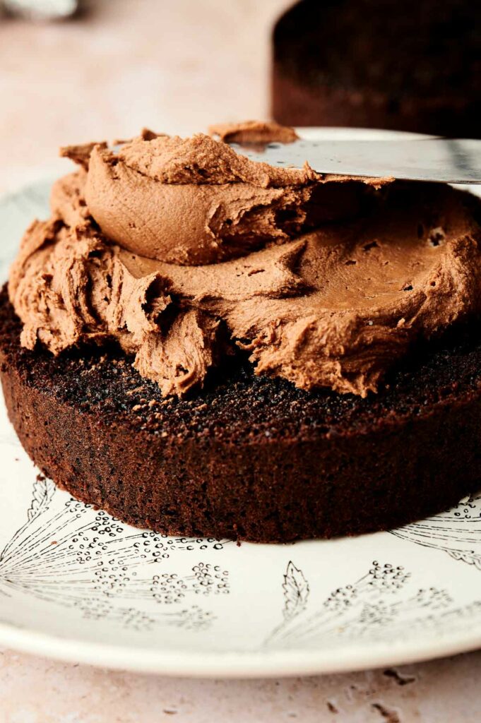 An air fryer cake with chocolate frosting on top.