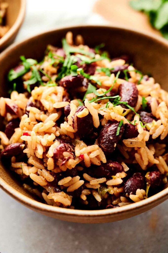 A bowl of Jamaican red beans and rice on a table.