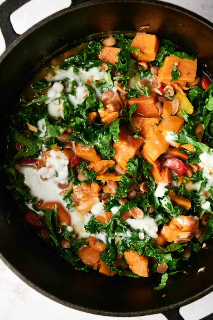 A pot with Thai Peanut Curry dish and coconut milk.
