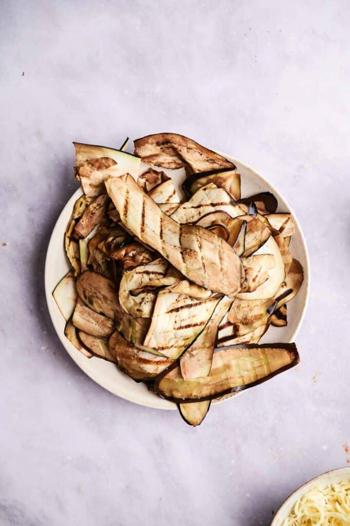 Grilled slices of eggplant on a plate.