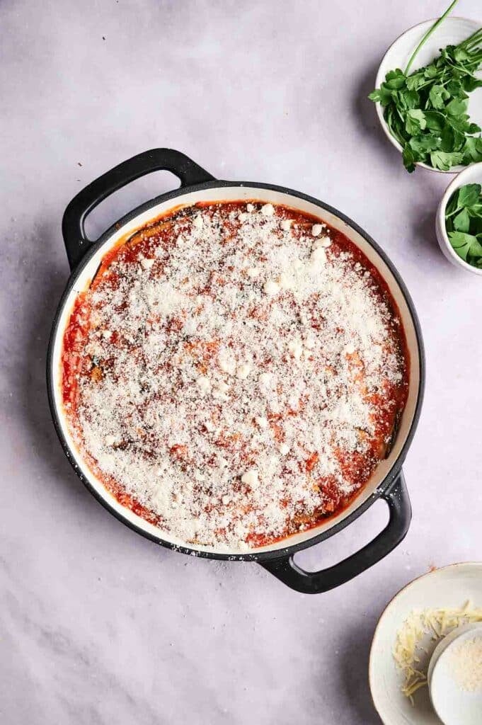 A pan of eggplant casserole with cheese and sauce.