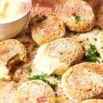 Chickpea nuggets on a baking sheet with dipping sauce.
