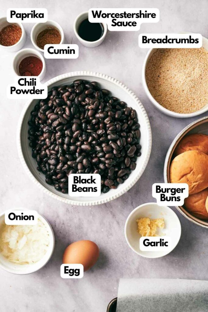 Ingredients for black bean slider neatly labeled and arranged on a kitchen surface.