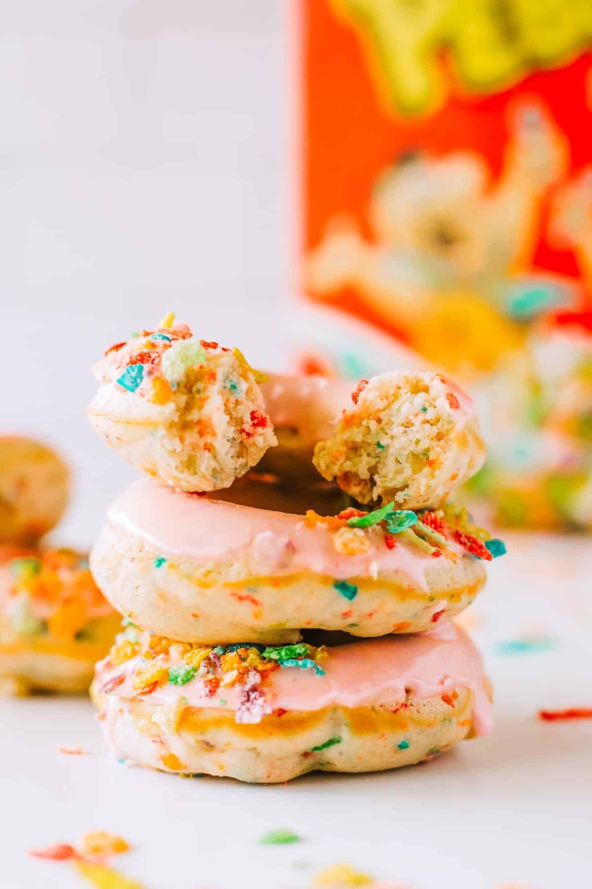 A pile of Fruity Pebbles Donuts on a white counter