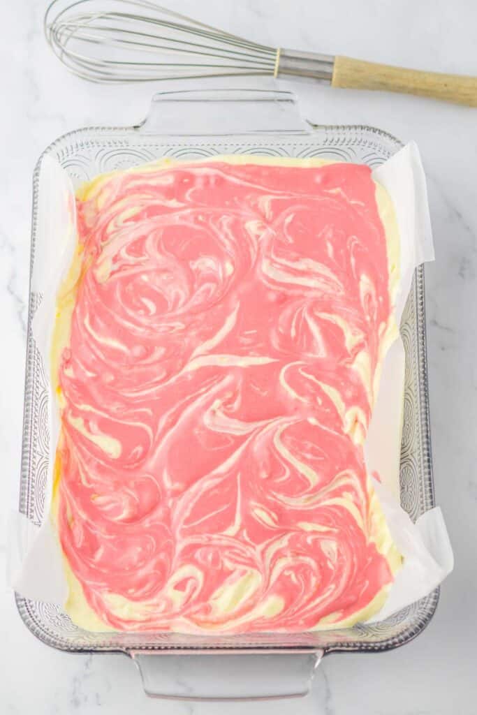 raspberry lemon cheesecake bars in a baking dish