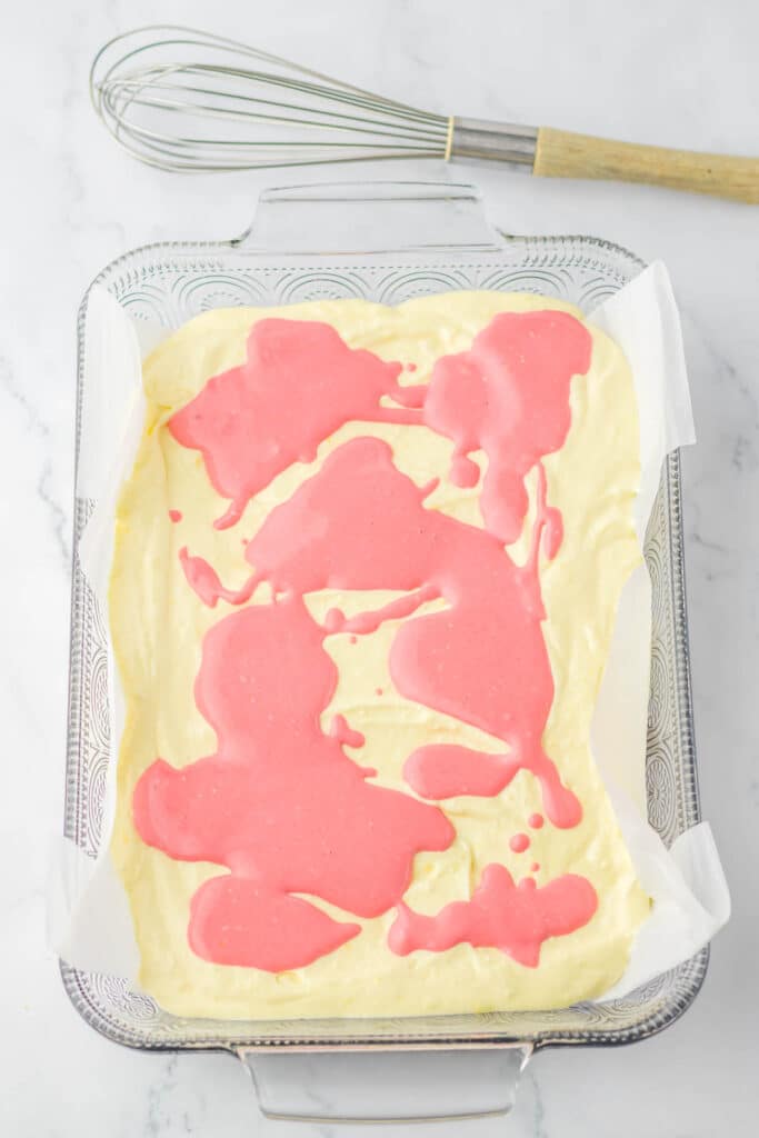 raspberry lemon cheesecake batter in a baking dish