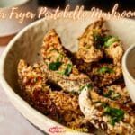 A bowl containing breaded, cooked portobello mushroom slices garnished with chopped herbs. The text "Air Fryer Portobello Mushrooms" is prominently displayed at the top of the image, highlighting this delicious dish.