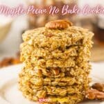 A stack of no-bake maple pecan cookies with whole pecans on a white plate, highlighted by a soft-focus background.