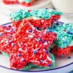 Patriotic Rice Crispy Treats: Star-shaped, red, white, and blue rice crispy delights adorned with sprinkles, all beautifully arranged on a white plate.
