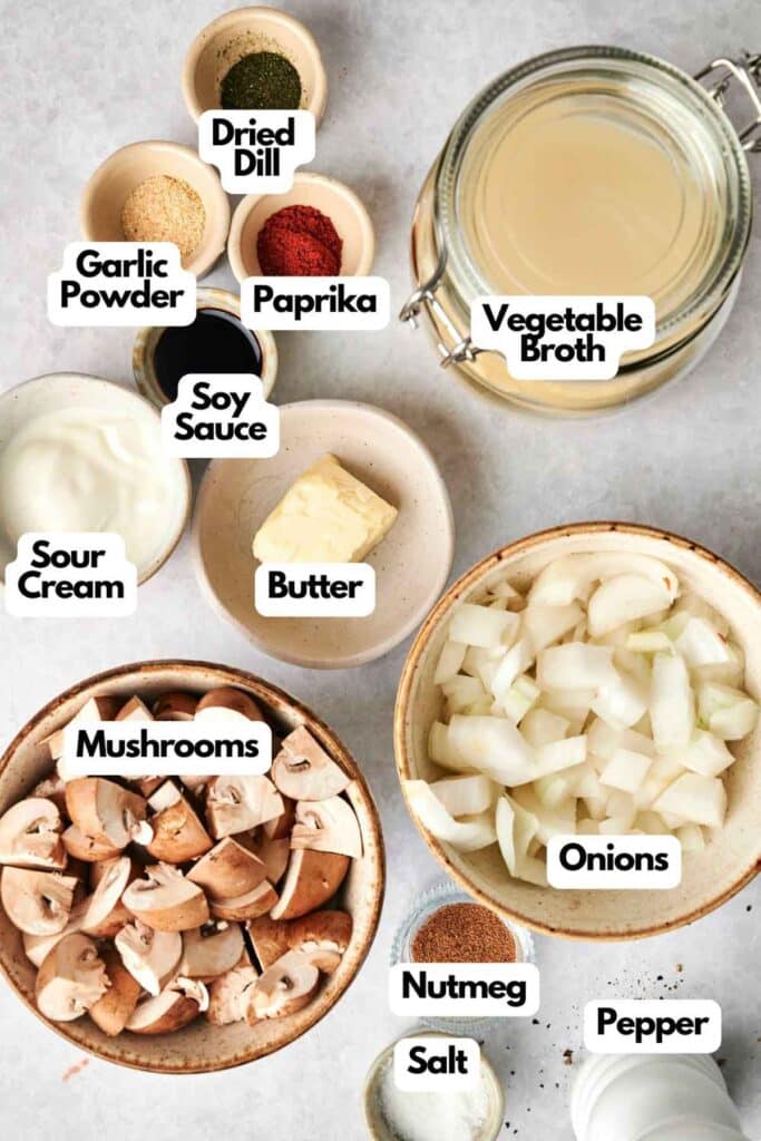 The perfect mushroom soup starts with labeled ingredients: garlic powder, paprika, dried dill, vegetable broth, and soy sauce. Add butter, sour cream, mushrooms, onions, nutmeg, salt, and pepper for a rich and savory delight.